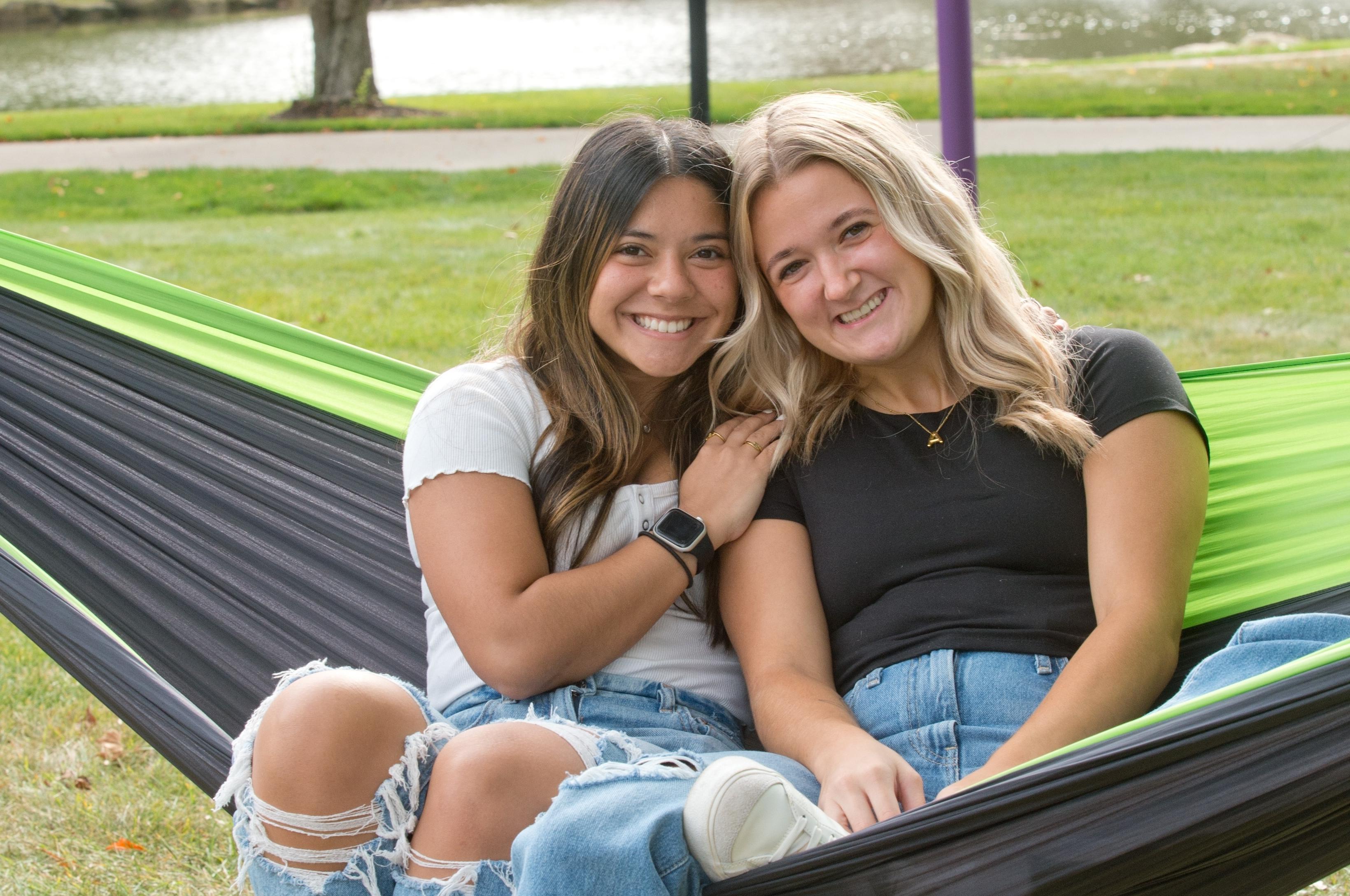 Mount 联盟 students smiling on a hammock by 的 lakes.